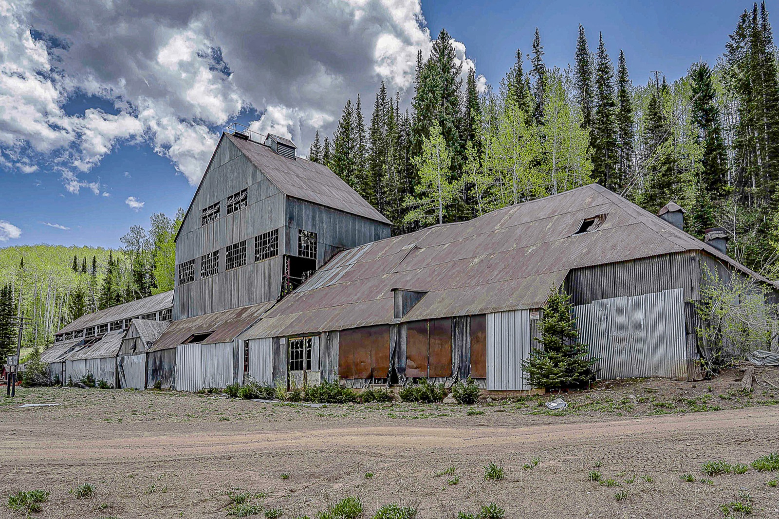 The weathered Silver King Mine building in 2021 before restoration, with rusted roofing and boarded windows